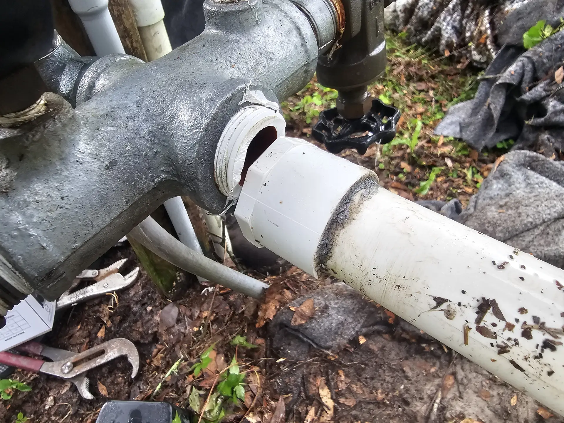 Cracked PVC fitting connected to metal piping